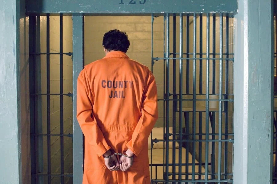 Handcuffed prisoner in jail child pornography
